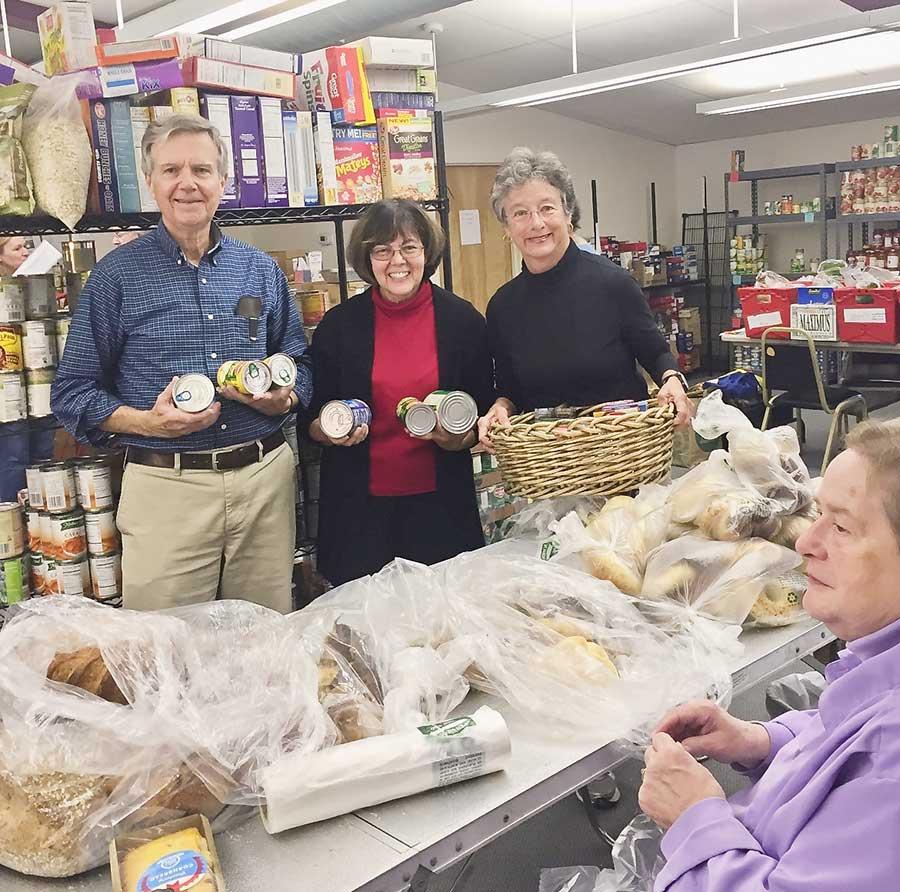 Volunteers prepare bags filled only with nutritious food items for its neighbors who need help in providing their families a Thanksgiving meal.